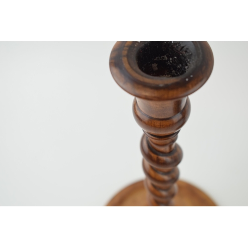 440 - A pair of 19th century olive wood turned candlesticks, weighted bases, 23cm tall.