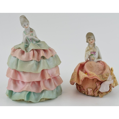 459 - A pair of ceramic dressing table dolls, early to mid 20th century, with fabric dresses, 13cm tallest... 