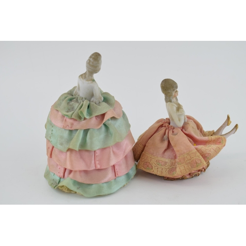 459 - A pair of ceramic dressing table dolls, early to mid 20th century, with fabric dresses, 13cm tallest... 