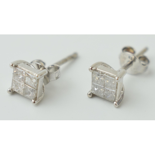 529 - A pair of sterling silver and diamond set earrings, with 8 individual square set diamonds, with cert... 