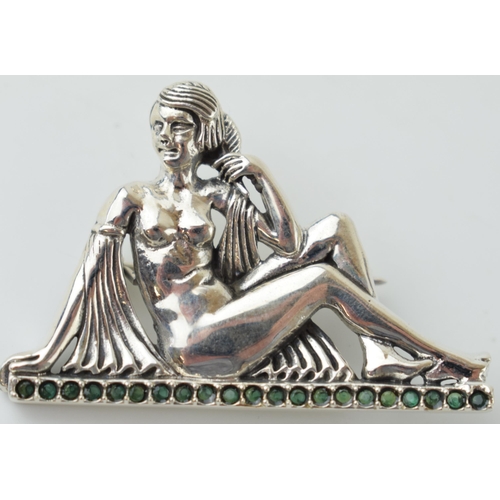 537 - Sterling silver brooch in the form of a sitting lady, stone set, 12.3g, 48mm wide.