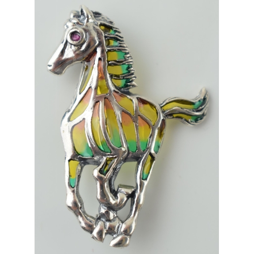 538 - Sterling silver brooch in the form of a running horse, with gem-set eye, 4.8g, 40mm tall.