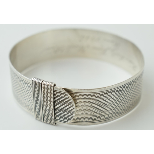 540 - Sterling silver buckle bangle, engineered design, engraving to inner, 29.2g, London 1945.