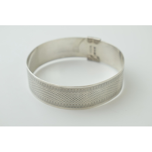 540 - Sterling silver buckle bangle, engineered design, engraving to inner, 29.2g, London 1945.