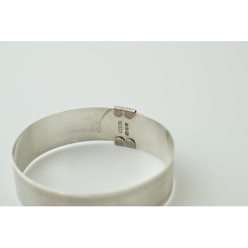 540 - Sterling silver buckle bangle, engineered design, engraving to inner, 29.2g, London 1945.