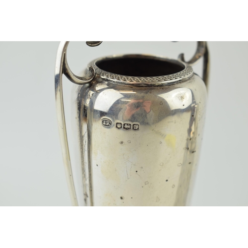 554 - A silver two handled cup, hallmarked Sheffield. Weight (186.6 grams), together with a silver topped ... 