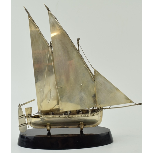 555 - A Sterling silver sail boat on aa base. Height 20cm.