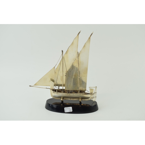 555 - A Sterling silver sail boat on aa base. Height 20cm.