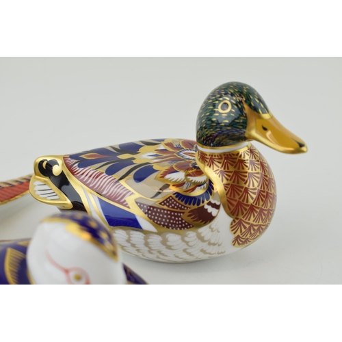 149 - Three Royal Crown Derby paperweights, Mallard, 15cm long, gold stopper and red Royal Crown Derby sta... 