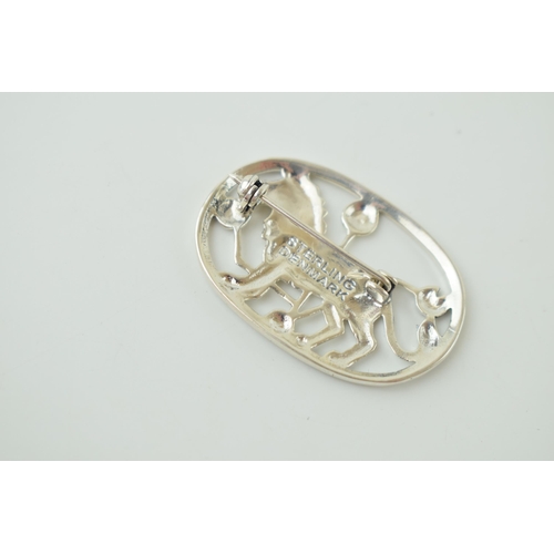 107 - Sterling silver brooch in the form of a stylized lion, Jensen style, 37mm wide.