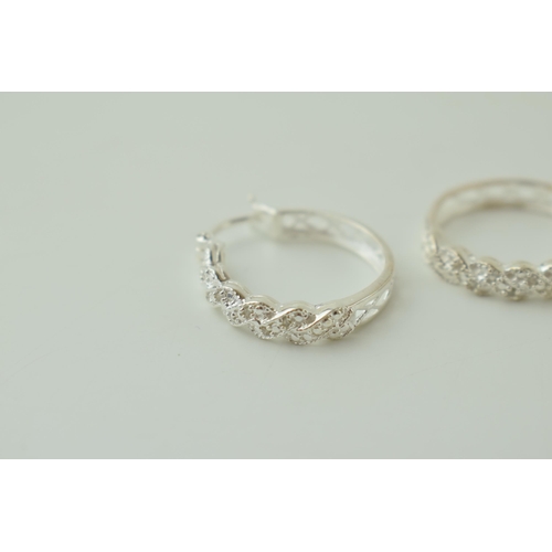 24 - A pair of silver ornate hoop earrings, 4.0g (2).