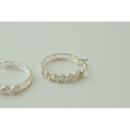 24 - A pair of silver ornate hoop earrings, 4.0g (2).