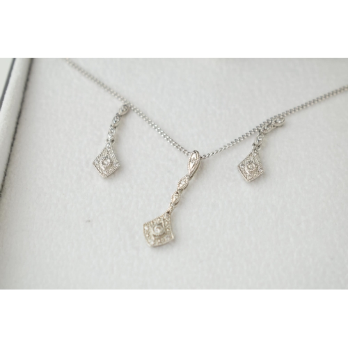 26 - 9ct white gold jewellery set to include a pair of earrings with a pendant and chain, all diamond set... 