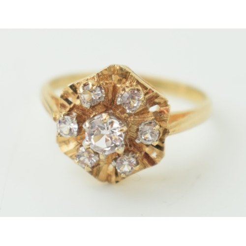 3 - 9ct gold ring with white stones in the form of a flower head, 2.1g, size K/L.