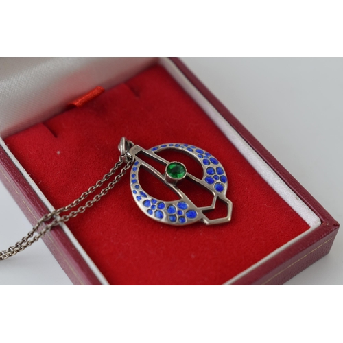 37 - Hallmarked silver enamelled pendant with central green paste stone with a white metal chain.