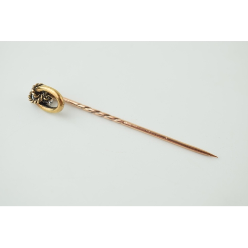 38 - 9ct gold stick pin with suspended diamond, 5.5cm long, 1.3g.