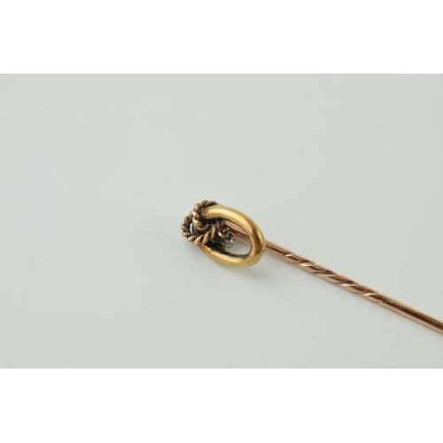 38 - 9ct gold stick pin with suspended diamond, 5.5cm long, 1.3g.