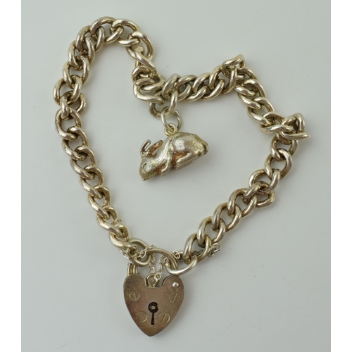 59 - A silver bracelet with heart shaped clasp and rabbit charm, 20.0 grams.