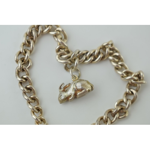 59 - A silver bracelet with heart shaped clasp and rabbit charm, 20.0 grams.