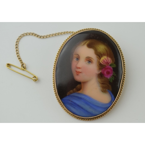 68 - 9ct gold framed brooch, porcelain painted plaque with a young girl with flowers in hair, 4.5cm tall,... 