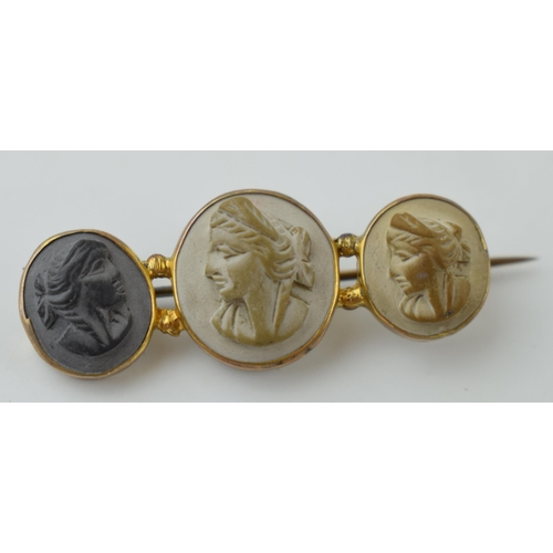 69 - Victorian gilt metal lava cameo brooch of three ladies, 52mm wide.