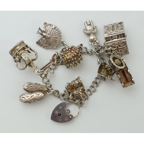 78 - Silver charm bracelet with charms to include a crown, a bear and others, 46g.