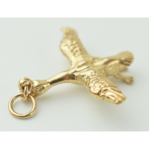 127 - 9ct gold charm / pendant in the form of a flying duck, 3.5 grams, 30mm long.