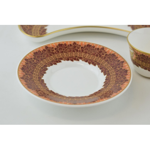 115 - De Lamerie Fine Bone China, heavily gilded, in the Winter Leaves pattern to include two tea cups, th... 