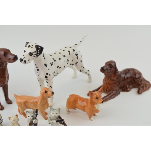 153 - Beswick to include a Dalmatian, a Corgi, a liver coloured spaniel, a lying spaniel, three of the Cat... 