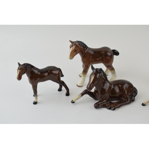 155 - Beswick to include 2 lying foals 915 (1 with Doulton backstop), 2 browns foal, a Sylvac foal and a p... 