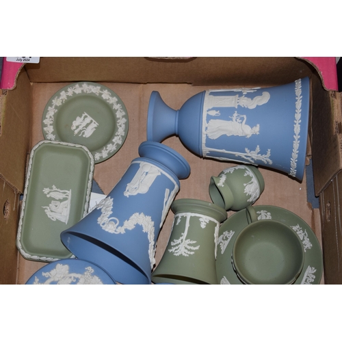 267 - Wedgwood Jasperware in green and blue to include a cup and saucer (cup chipped), vases, a spare urn ... 