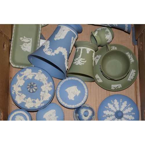 267 - Wedgwood Jasperware in green and blue to include a cup and saucer (cup chipped), vases, a spare urn ... 