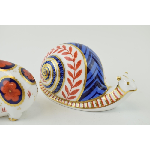 27 - Royal Crown Derby paperweights in the form of an imari pig and a garden snail, both first quality, c... 