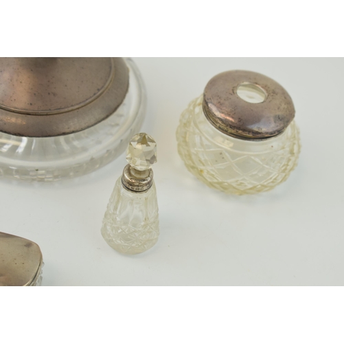 595 - A collection of silver and glass items to include a small scent bottle, a large compact with mirror,... 