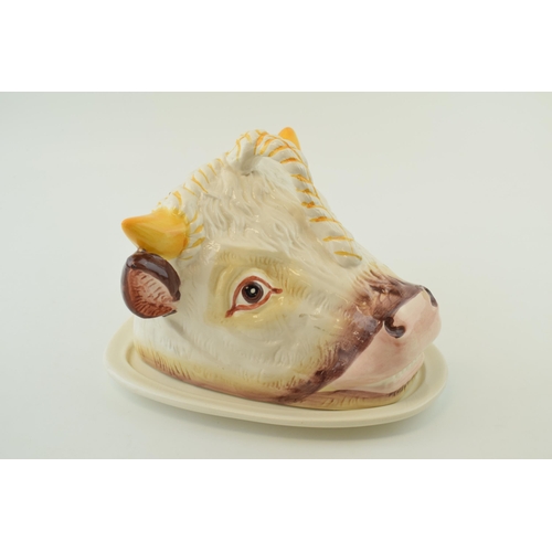 104 - A pottery novelty cheese / butter dish in the form of a Hereford Bull head, 24cm wide.