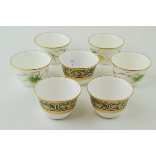 111 - De Lamerie Fine Bone China tea cups to include three with a gilt jewel-work on red and green called ... 