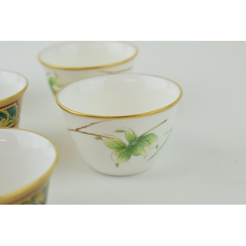 111 - De Lamerie Fine Bone China tea cups to include three with a gilt jewel-work on red and green called ... 