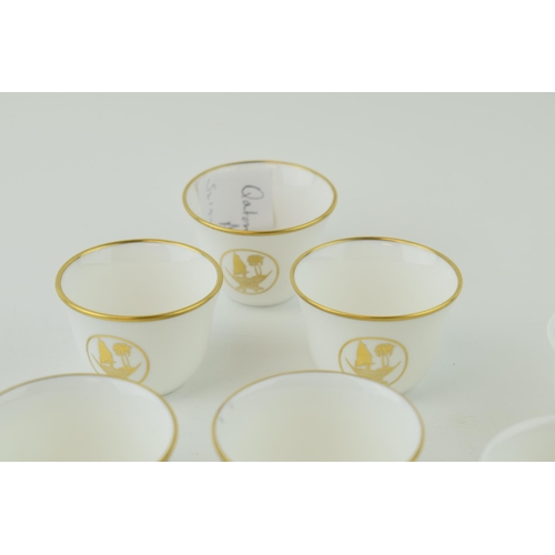 113 - De Lamerie Fine Bone China tea cups with gilt design and Qatar Coat of Arms, in three varying styles... 