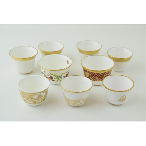 114 - De Lamerie Fine Bone China tea bowls and similar to include a red spiral and twist cup, a floral exa... 