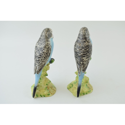 150 - A pair of Beswick Blue Budgerigars / Budgies, both 1217, both with damages (2).