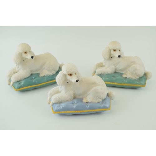 167 - A trio of Beswick models of a Poodle on Cushion 2985, 2 with a turquoise cushion and one on a lilac ... 