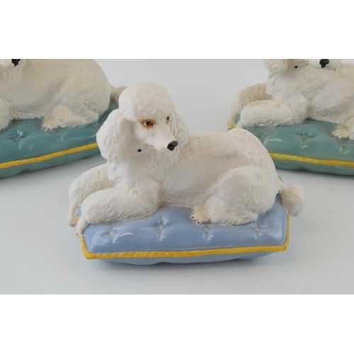 167 - A trio of Beswick models of a Poodle on Cushion 2985, 2 with a turquoise cushion and one on a lilac ... 