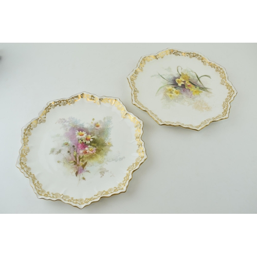 197 - A pair of Doulton Burslem cabinet plates, with shaped edges, of floral scenes, 22.5cm diameter (2).