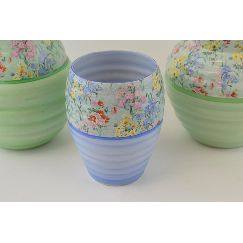 235 - A trio of Shelley China Art Deco ribbed vases in the Melody pattern to include a blue background exa... 