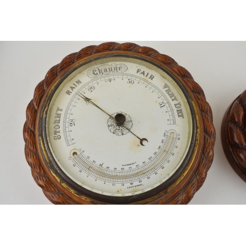 281 - A barometer with intergrated thermometer. Golden oak case. White dial with brass hand. Diameter 22cm... 