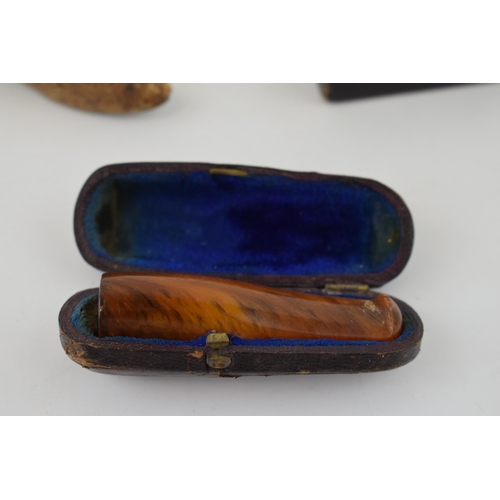 286 - A collection of items to include an
 cased amber cigar holder, paper mâché snuff box and a vesta cas... 