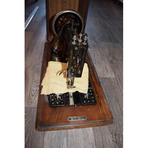 299 - Cased Simplex hand driven sewing machine inlaid mother of pearl decoration, in inlaid case, 53cm wid... 