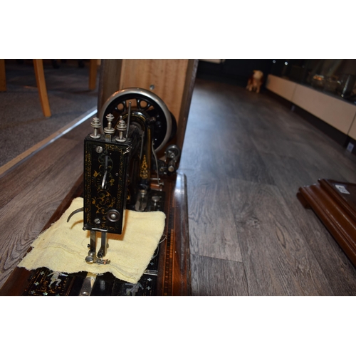 299 - Cased Simplex hand driven sewing machine inlaid mother of pearl decoration, in inlaid case, 53cm wid... 