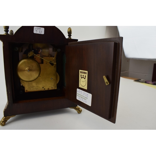 86 - Wuba Warmink mahogany and similar cased mantel clock with metal roman numeral dial, supported on bra... 