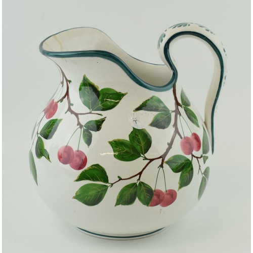 91 - Large Wemyss Ware bulbous jug, decorated with plums and foliage, impressed marks and stamped retaile... 